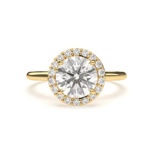 Close-up of LILOU halo engagement ring crafted in yellow gold