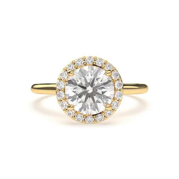 Close-up of LILOU halo engagement ring crafted in yellow gold