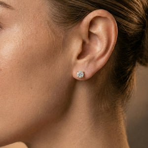 Classic diamond studs 18k yellow gold on ear of model