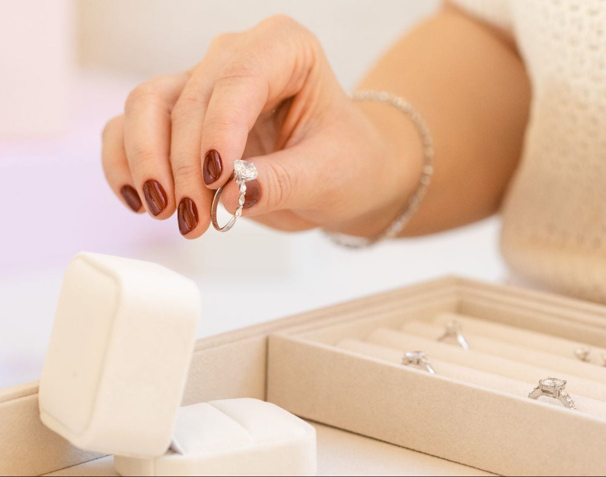 Hand holding a natural diamond engagement ring from CAREDIAMONDS – showcasing refined craftsmanship, brilliance, and timeless responsible luxury.